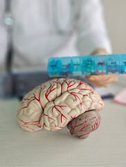 Doctor holds psycho neurological pills for brain in hands