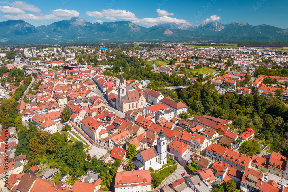 Wall mural Aerial view of the Kranj town with mountain range at background, Slovenia.