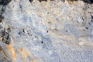 Rockfall at mountain village of Brienz Brinzauls with helicopter and workers hanging on rope in the Swiss Alps on a sunny autumn day. Photo taken November 15th, 2024, Brienz Brinzauls, Switzerland.