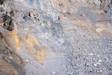 Rockfall at mountain village of Brienz Brinzauls with helicopter and workers hanging on rope in the Swiss Alps on a sunny autumn day. Photo taken November 15th, 2024, Brienz Brinzauls, Switzerland.