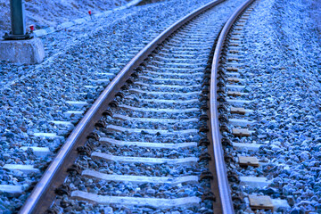 High angle view of railroad tracks with curve of narrow gauge railway near mountain village Surava...