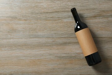 Bottle of red wine on wooden background