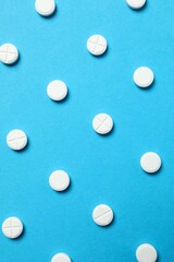 White pills on color background