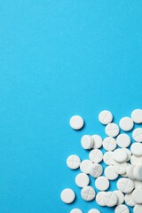 White pills on color background