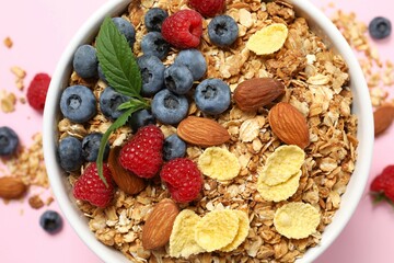 Delicious granola with berries on a color background
