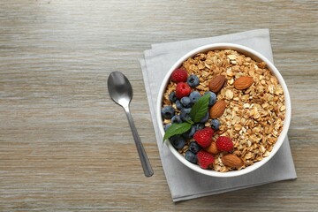 Delicious granola with berries on a wooden background