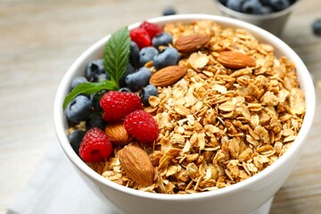 Delicious granola with berries on a wooden background