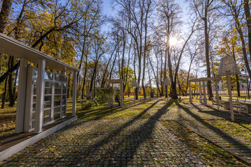 A park with a white building and a few trees