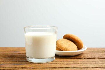Glass of milk with cookies on the table