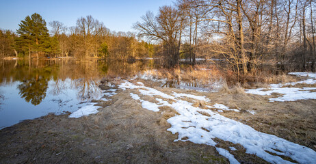 Snowy field with a body of water in the background
