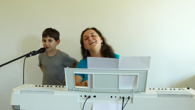 Music lesson. Boy is things the song and learns to play piano