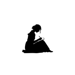 Silhouette of a woman sitting on the floor writing in a notebook