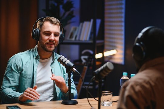 Man recording podcast using high tech microphones to interview guest, ensuring flawless video and sound quality for audience