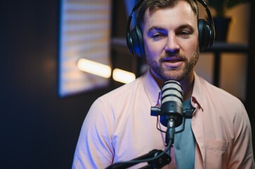 Man smiling while recording podcast in studio