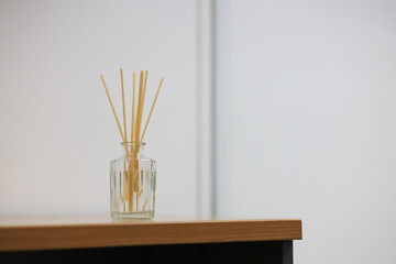 Reed diffusers in perfume bottles are placed on the table. Reed diffusers help create a good atmosphere for a place.