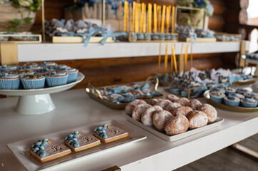 Sweets, cupcakes, toys, treats, and gifts for guests at a baby’s christening celebration.
