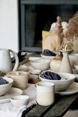 Rustic table setting with empty craft handmade ceramic tableware