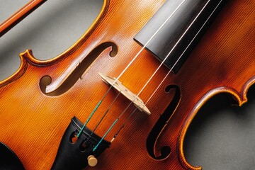 Close-up of a beautifully-crafted violin, highlighting its curves and strings, encapsulating the art and elegance of this classical instrument.