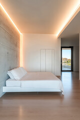 Fototapeta premium Modern minimalist bedroom with unique lighting and large window showcasing the outdoors