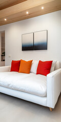 Modern living room featuring a white couch with colorful cushions and contemporary art