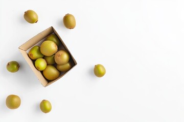 Top view of fresh kiwis in a small cardboard container, with a few kiwi scattered around, set against a clean white background