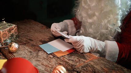 Santa Claus Is Reading The Children's First Christmas Letters On The Desk