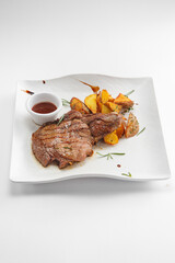 Steaks with garnish and sauces