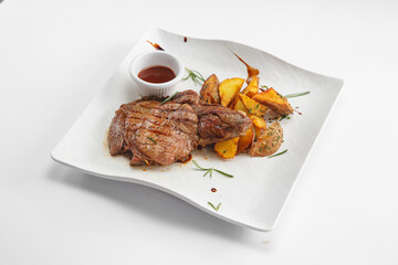 Steaks with garnish and sauces