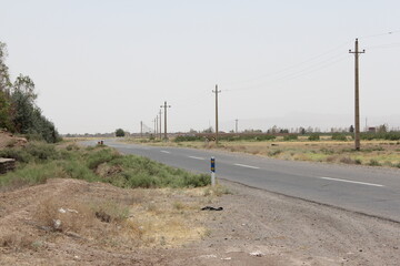 Empty asphalt road stretching through the desert, symbolizing solitude and the journey through remote areas.