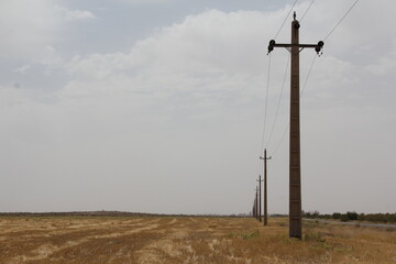 Two utility poles in an empty desert, conveying a sense of solitude and isolation.