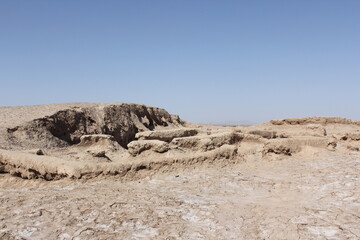 Stone ruins in an arid desert landscape, highlighting the historical significance and architectural prowess of ancient builders.