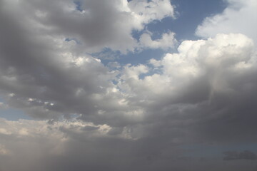 Cloudy desert sky with dramatic light, capturing the rugged beauty and atmosphere of Middle Eastern landscapes.