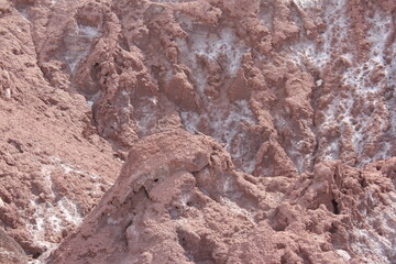 Rocky desert cliffs with dramatic textures and earthy colors, showcasing rugged terrain and natural formations.