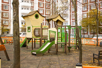 Bright playground in the park. Playground with slides and swings for children.