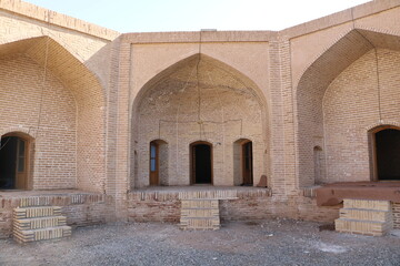 Ancient Persian courtyard with arches, showcasing the timeless beauty and architectural elegance of Iranian heritage.