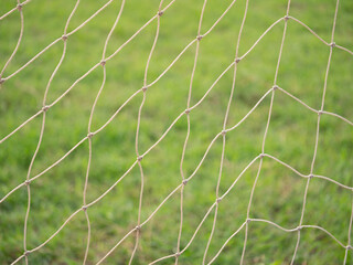 Soccer field netting close-up green grass sports equipment outdoor setting detailed view sports...