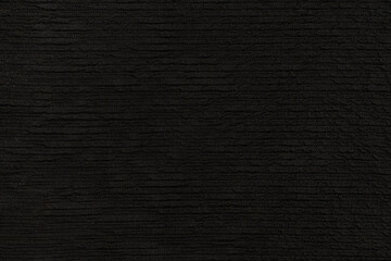 abstract background of black silk voluminous knit fabric close up