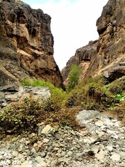 A breathtaking desert vista with layered rock formations and a bright blue sky, highlighting the dramatic geology of arid Persian regions.