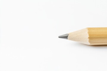CloseUp of a Wooden Pencil Tip Set Against a Clean White Background Surface. Detailed close up view of a finely sharpened pencil. Pristine white backdrop. Pencil point. Business and education concept