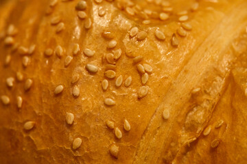 background crust of sweet bun sprinkled with sesame seeds