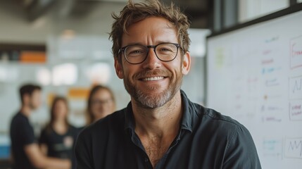 Obraz premium Confident Businessman Standing in Front of Whiteboard with Colleagues in Background, Showcasing Success and Professionalism in Modern Office Setting