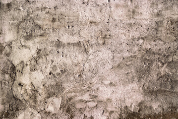The photo shows an old brown concrete wall