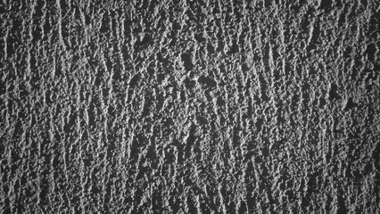 The photo shows grey decorative plaster on the wall