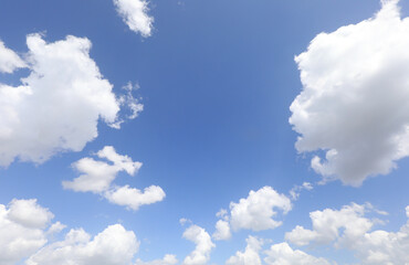 Obraz premium clouds on a blue sky and a space in the center to insert a photo or a personalized text among the clouds