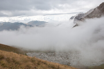 Caucasus mountains including Mount Fisht covered with a thick fog in autumn, Russian Federation