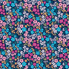 Cute floral background. Floral pattern with small colorful flowers on a dark blue background. Seamless pattern for design and fashion prints. Ditsy style. Stock vector illustration.