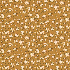 Elegant floral pattern in small hand draw flowers. Liberty style. White flowers, gold background. Floral seamless background for fashion prints. Vintage print. Seamless vector texture. Spring print