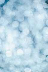 Blurred circles of pale blue light create a bokeh effect