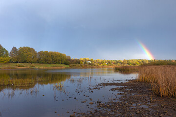 Landscape. Rainbow over the river