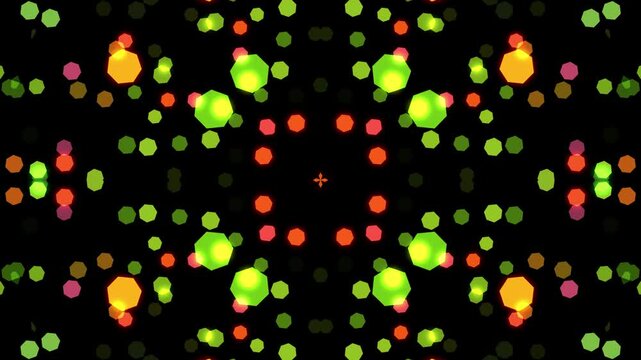 Symmetrical abstract pattern with glowing green, orange, and yellow heptagonal bokeh lights in a kaleidoscopic composition on a dark background.
